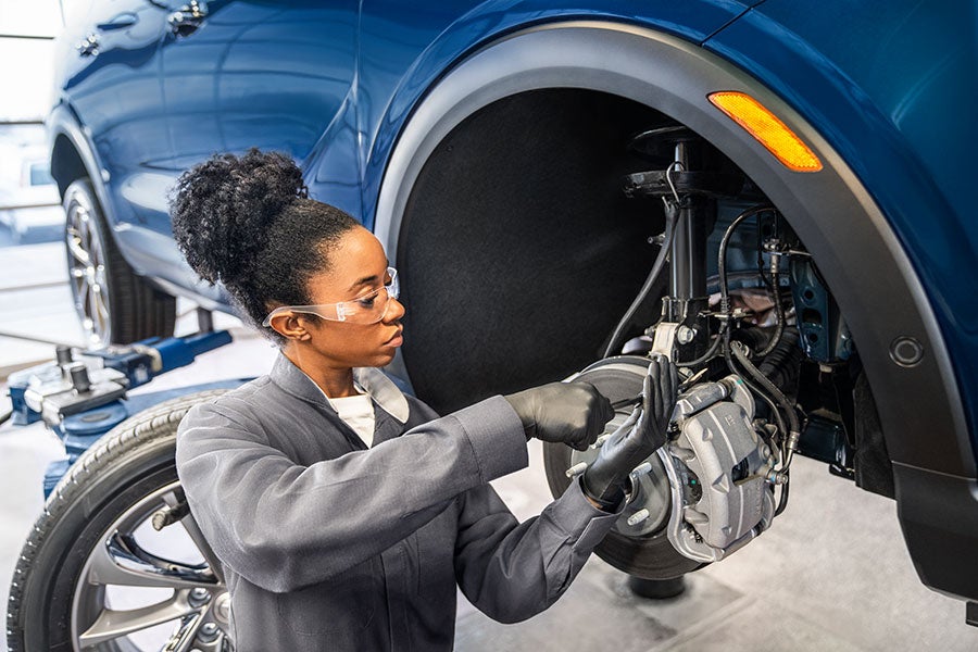 Service employee working on car brakes