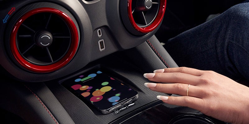 A woman's hand reaches for her phone.